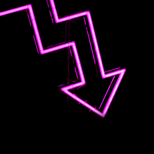 Pink neon arrow pointing down on a black background