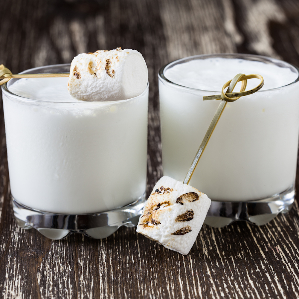 Homemade milkshake in glasses and toasted marshmallows