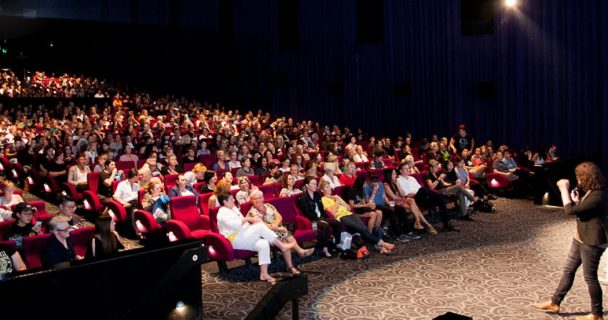 Festival Director Lisa Rose addressing an audience in cinema