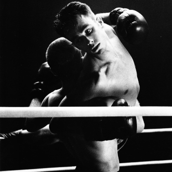 A still from the film Resonance, featuring a male boxer being lifted like a dancer by another male boxer