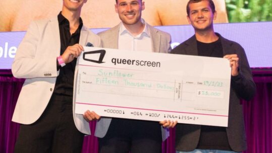 Queer Screen Completion Fund 2023 recipients holding large cheque worth $15,000.