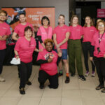 A group of pink shirt volunteers