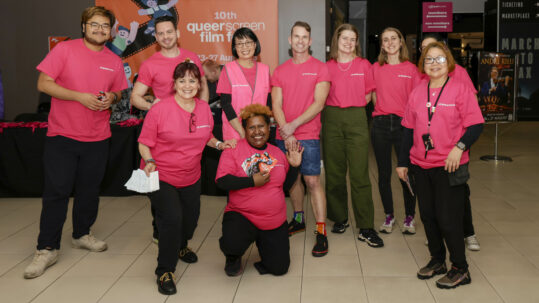 A group of pink shirt volunteers