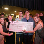 People posing with a novelty cheque at the MGFF24 Program Launch Party.