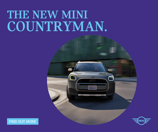 Advertising for Mini. A photo of the new Mini Countryman, shown front on in a grey green colour, is shown coming around a bend in the the road. Text reads: The new Mini Countryman. Find out more.