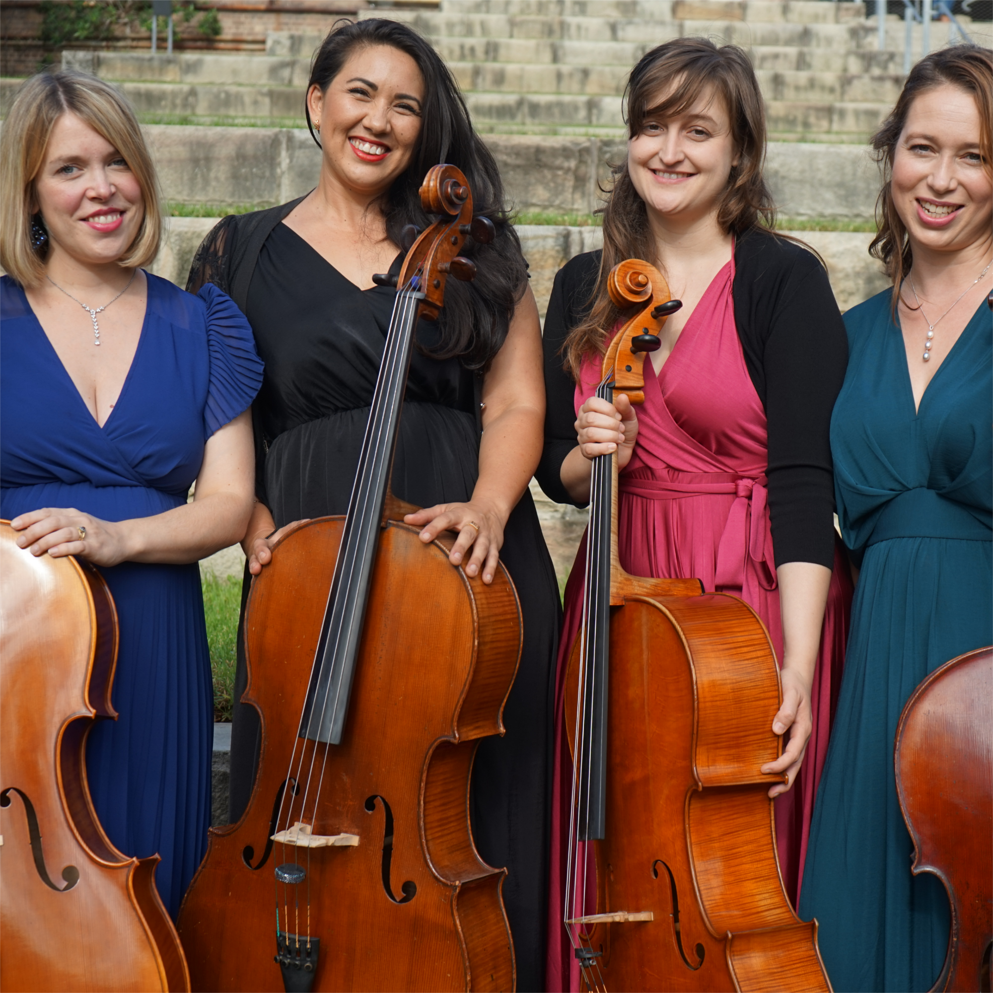 A photo of four people with their cellos, the members of the Sydney Cello Quartet.
