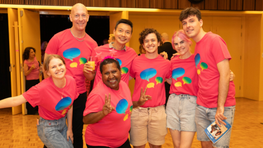 A photograph of Queer Screen volunteers smiling and posing together.